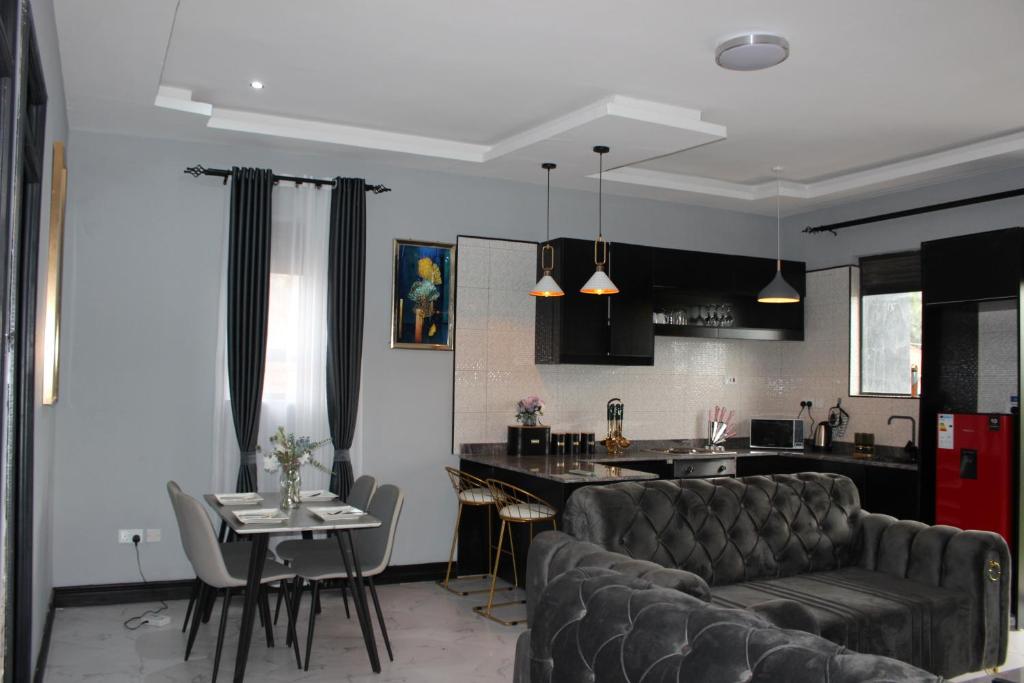 a living room and kitchen with a couch and a table at MHP Apartments in Munyonyo
