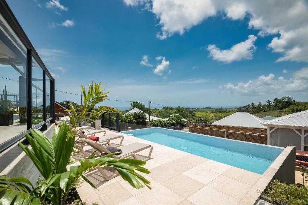 a swimming pool on the roof of a house at Les maisons Cane in Sainte-Rose
