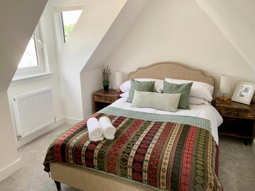 a bedroom with a bed with two slippers on it at Stunning Apartment in Callander in Callander