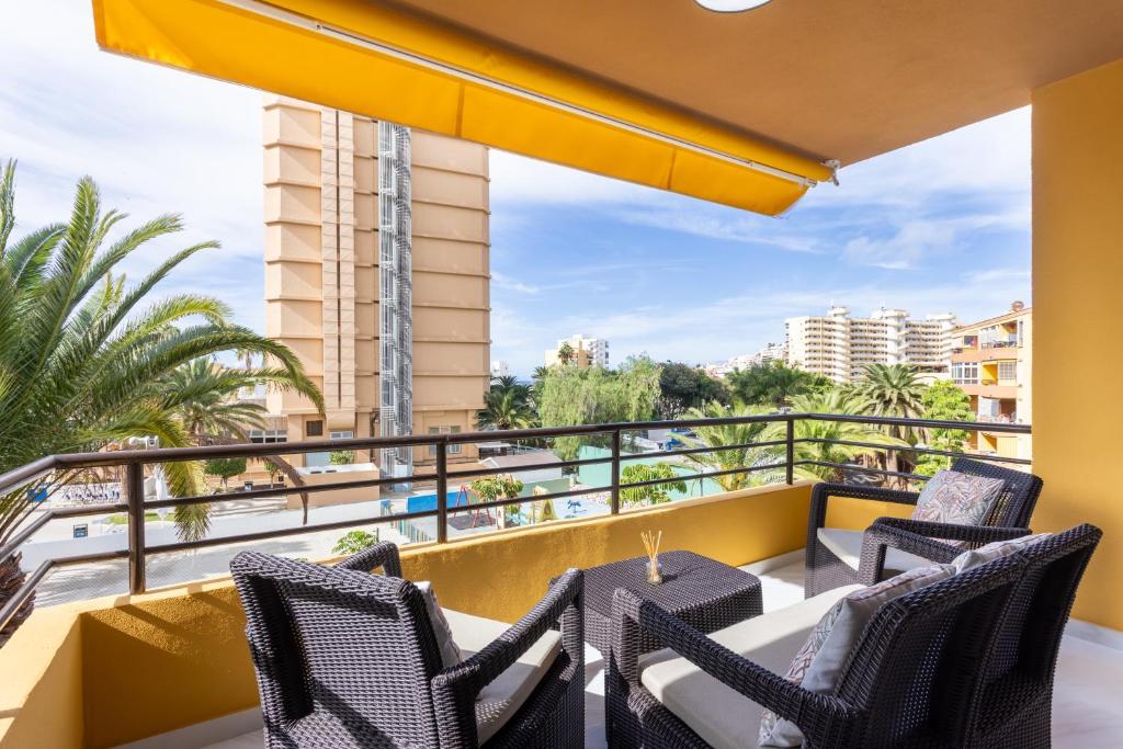 a balcony with chairs and a table with a view at Apartamento Clara in Los Cristianos