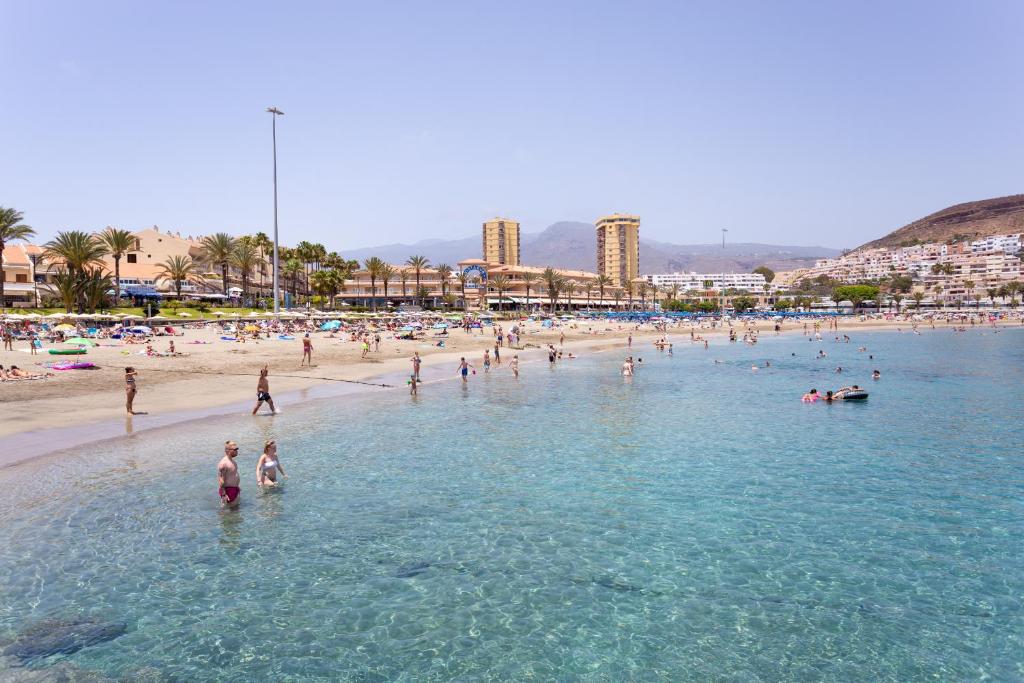 a group of people in the water at a beach at Apartamento Clara in Los Cristianos