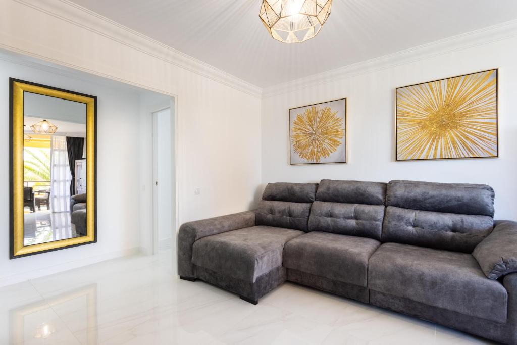 a living room with a couch and a mirror at Apartamento Clara in Los Cristianos