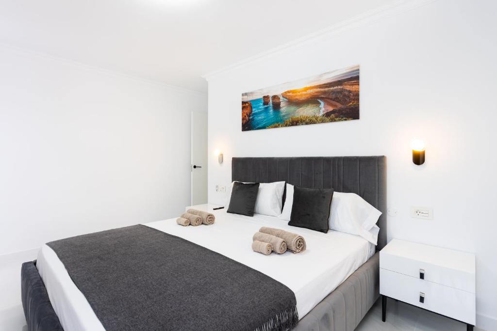 a bedroom with a large bed with two towels on it at Apartamento Clara in Los Cristianos