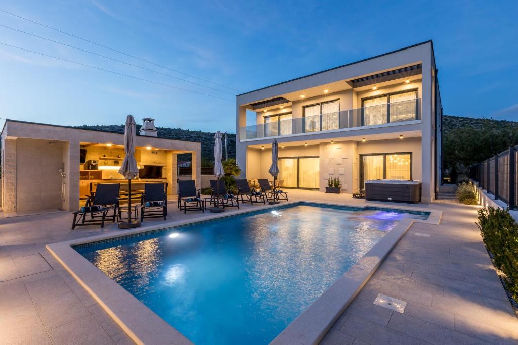 a swimming pool in the backyard of a house at Luxury Villa Diana with heated pool and jacuzzi in Dograde
