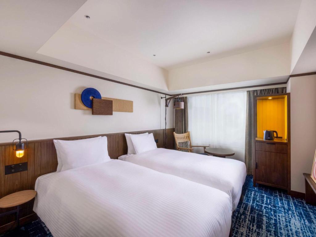 Postel nebo postele na pokoji v ubytování Mercure Hida Takayama