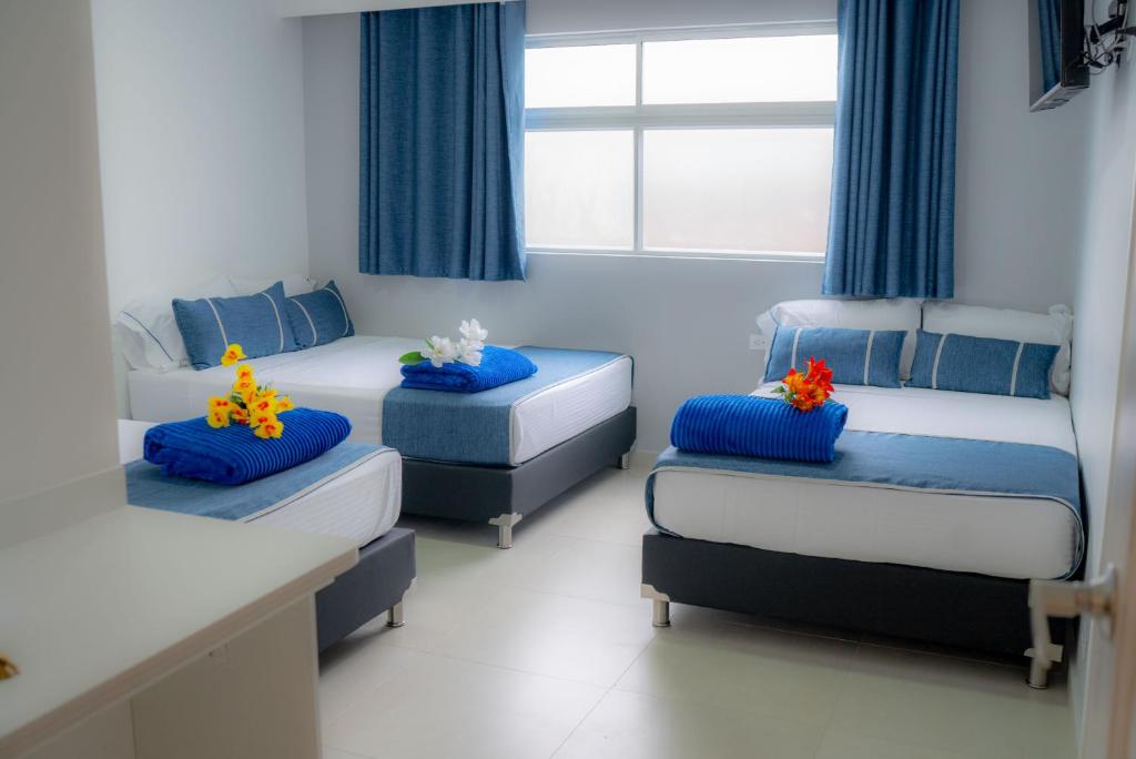 Postel nebo postele na pokoji v ubytování El Oscar Hotel