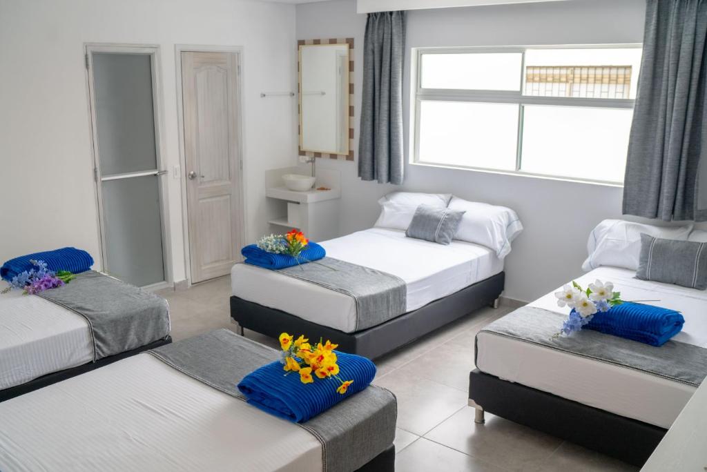 Postel nebo postele na pokoji v ubytování El Oscar Hotel