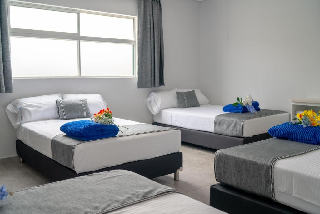 Postel nebo postele na pokoji v ubytování El Oscar Hotel