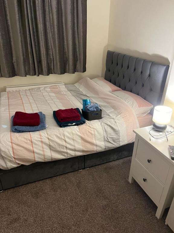 a bedroom with a bed with two towels on it at 2 St Jude’s Court, Woodlawn Park Grove, Firhouse, Dublin D24H1X4 in Dublin