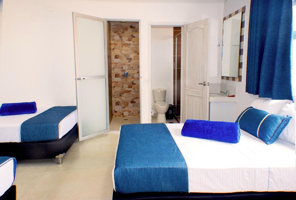 Postel nebo postele na pokoji v ubytování El Oscar Hotel