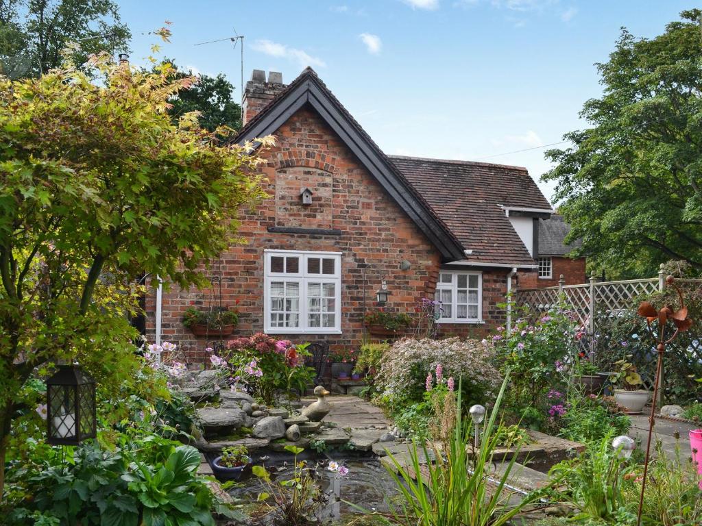 a brick house with a garden in front of it at The Stables in Hedon
