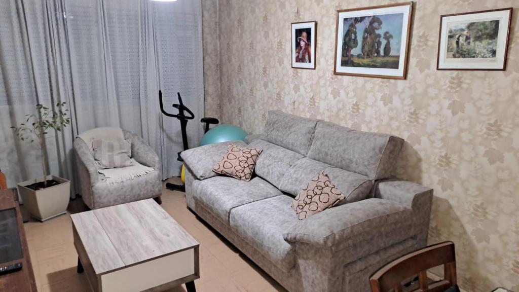 a living room with a couch and a chair at DEPARTAMENTO AUGUSTO- Excelente ubicacion en pleno centro de Mendoza in Mendoza