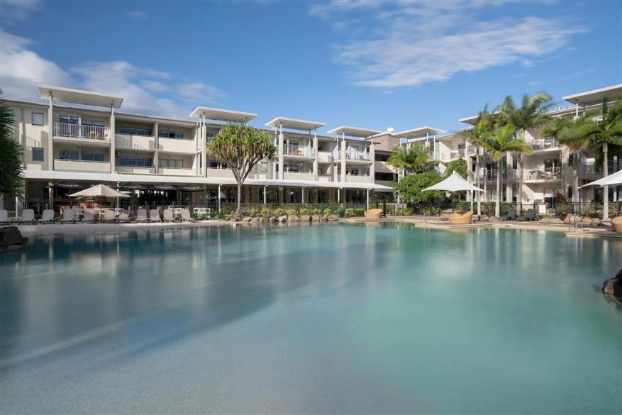 a large swimming pool in front of a hotel at Peppers Salt Resort & Spa 2 br luxury spa suite in Kingscliff