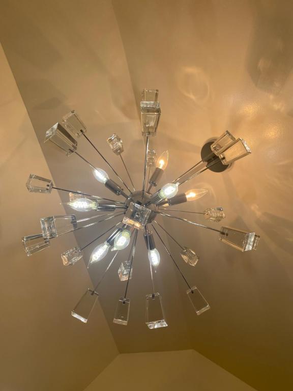 a chandelier hanging from a ceiling at Cheerful New Renovated One Private Bedroom in Morris Park