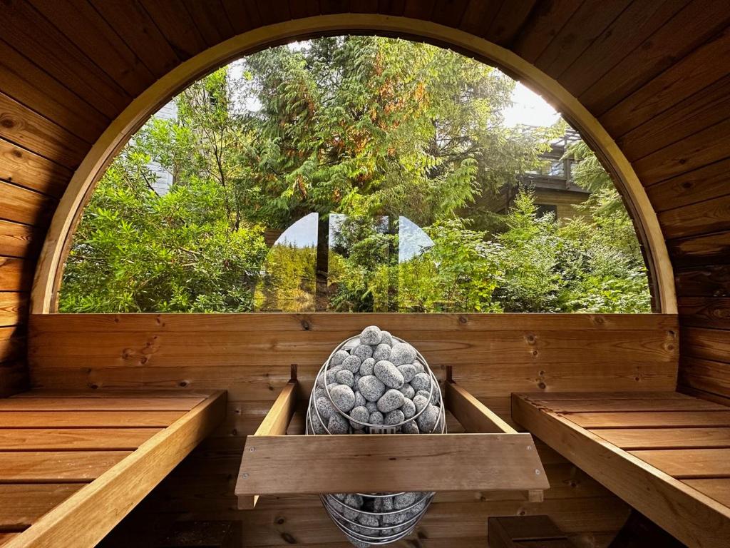 a large window in a wooden room with a bowl of fruit at Liahona Guest House in Ucluelet