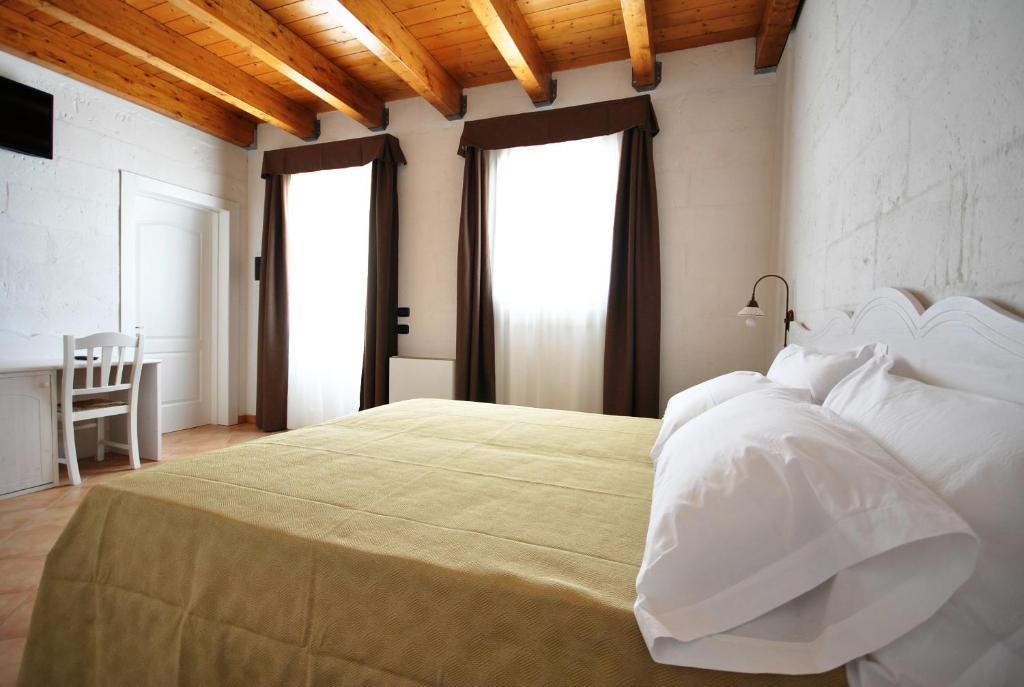 Postel nebo postele na pokoji v ubytování Tenuta Kyrios Agriresort Restaurant & Pool