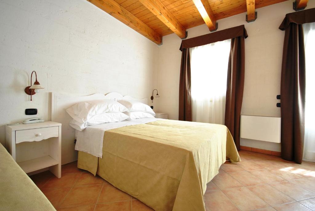 Postel nebo postele na pokoji v ubytování Tenuta Kyrios Agriresort Restaurant & Pool