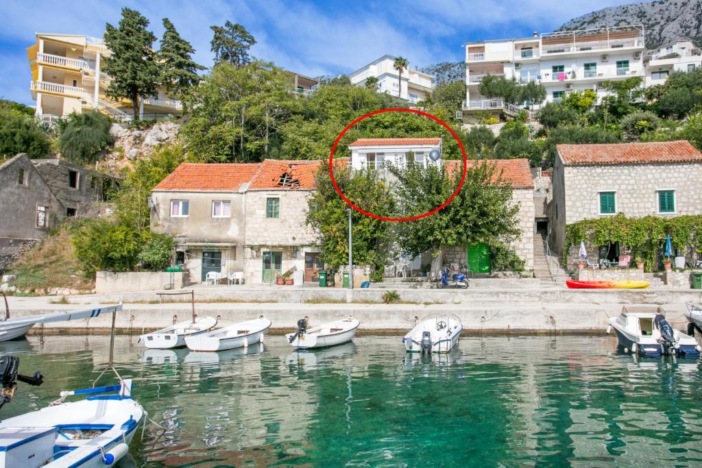 a group of boats in a body of water at Apartments by the sea Zivogosce - Porat, Makarska - 20207 in Igrane