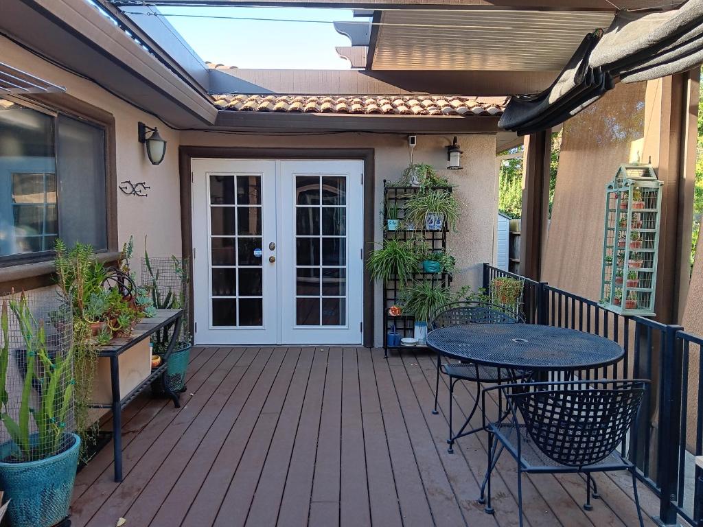 a wooden deck with a table and a patio at Arden Park Charm in Sacramento