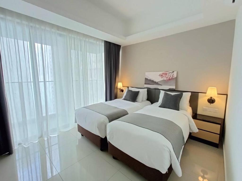 two beds in a hotel room with windows at Genting Peak 2BR6Pax421 @Ion Delemen in Genting Highlands