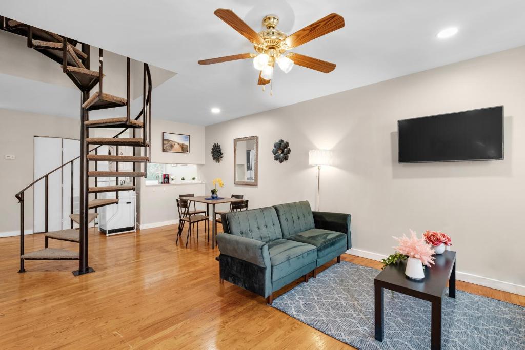 a living room with a couch and a ceiling fan at Modern And Cozy 2br Apt in Philadelphia