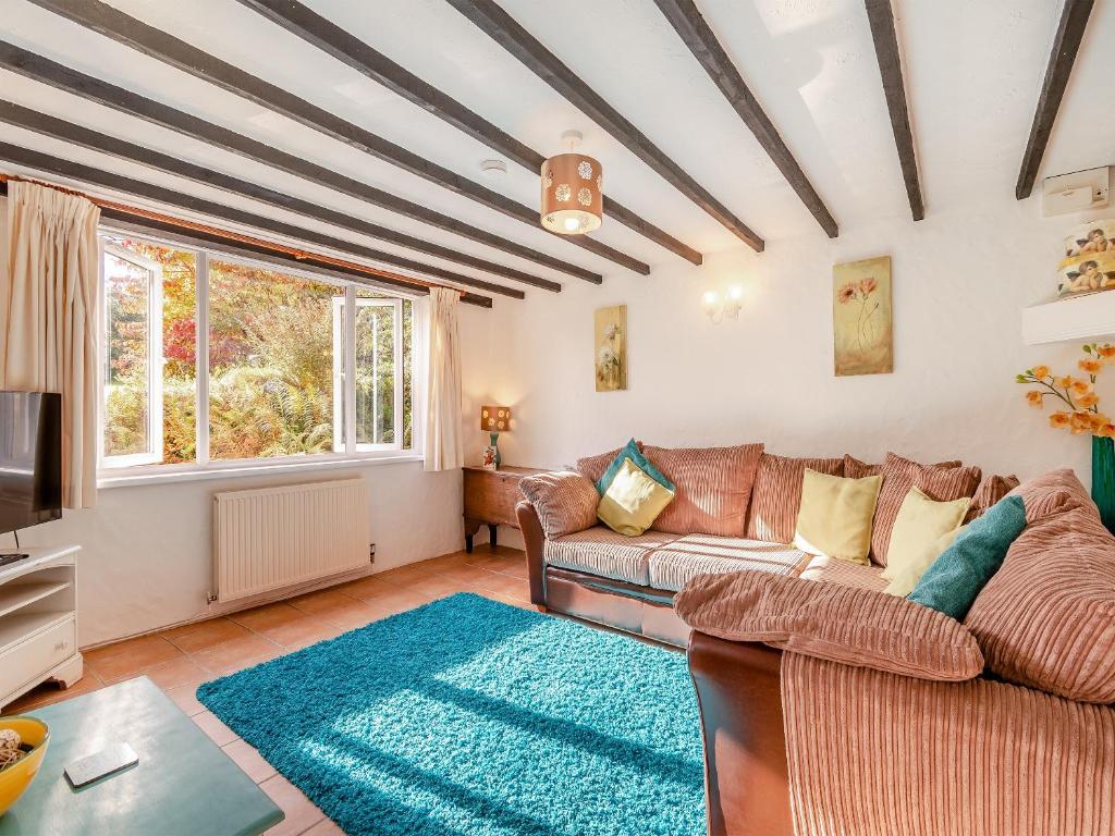 a living room with a couch and a tv at Dairy Cottage-uk45593 in Verwick