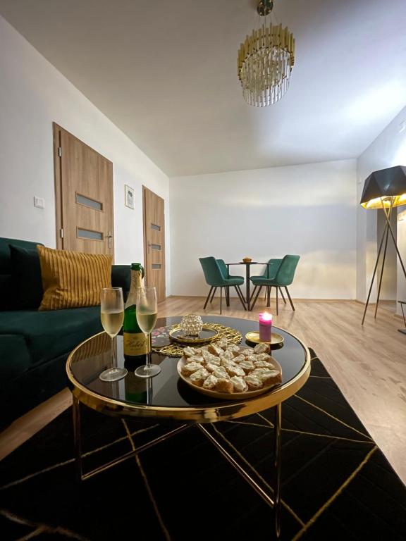 a living room with a table with food and wine glasses at Apartmán Miriam in Nitra