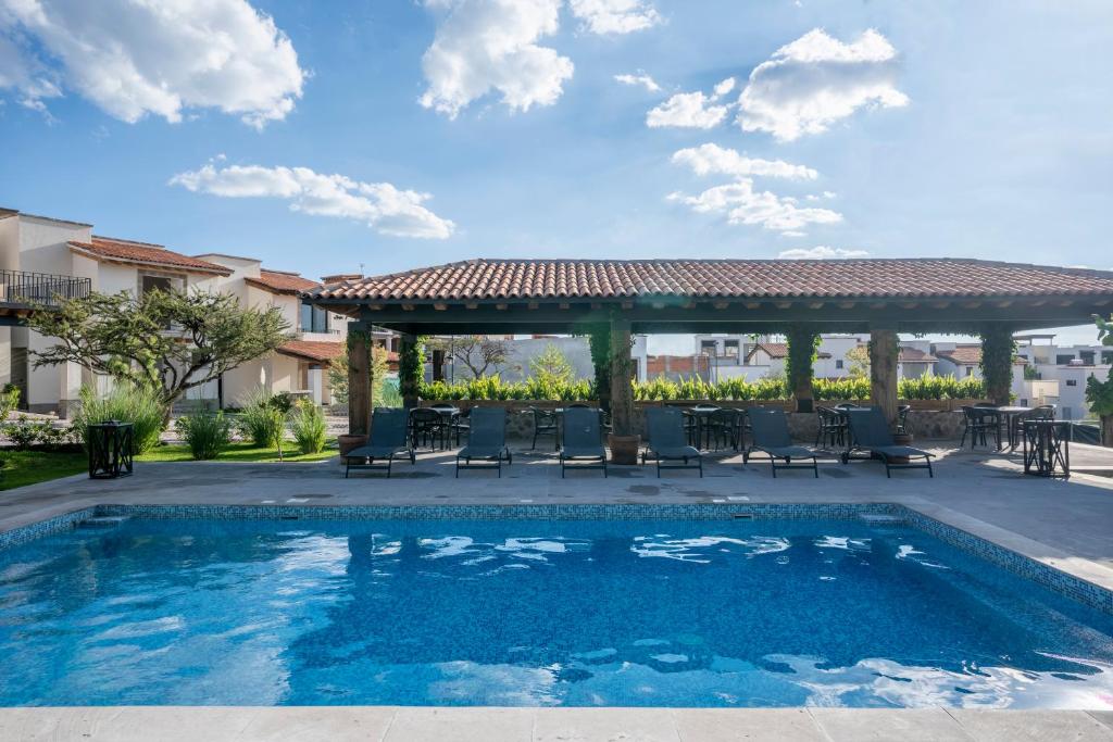 uma piscina com cadeiras e um gazebo em Private Sanctuary 4BR Home with Pools and Gym em San Miguel de Allende