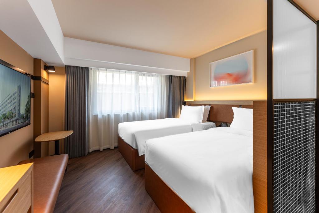 Postel nebo postele na pokoji v ubytování Mia Hotel - Shanghai Xuhui Jiaotong University