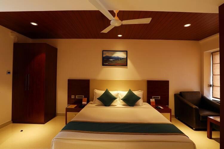 a bedroom with a bed and a ceiling fan at Jubilee hotel in Calangute