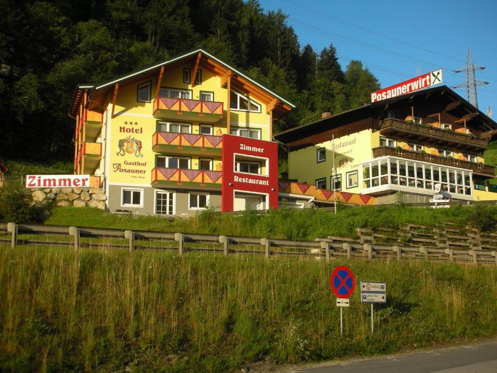 a building on the side of a road next to a street at Hotel Posauner in Sankt Veit im Pongau