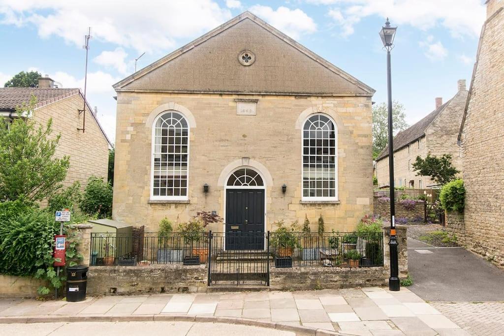 a large brick building with a black door at 3 bedroom converted chapel in historic Oundle in Oundle