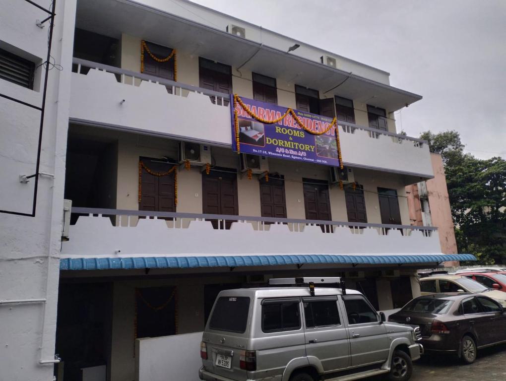 a building with a van parked in front of it at Hotel Sharma Residency Chennai Egmore in Chennai