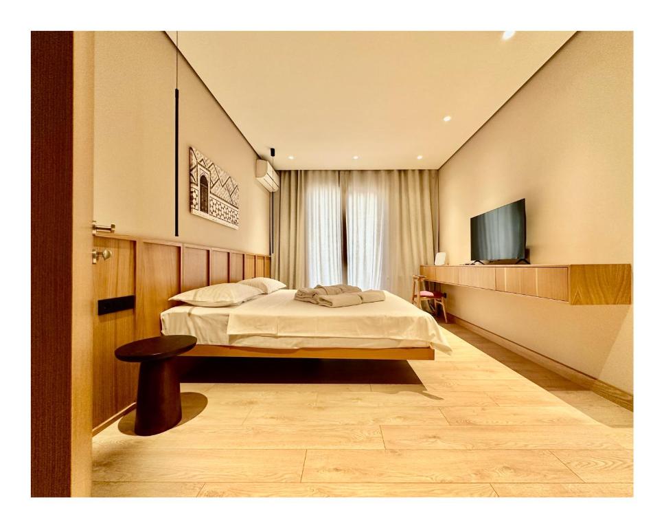 a hotel room with a bed and a television at Deluxe Apartment in Tashkent