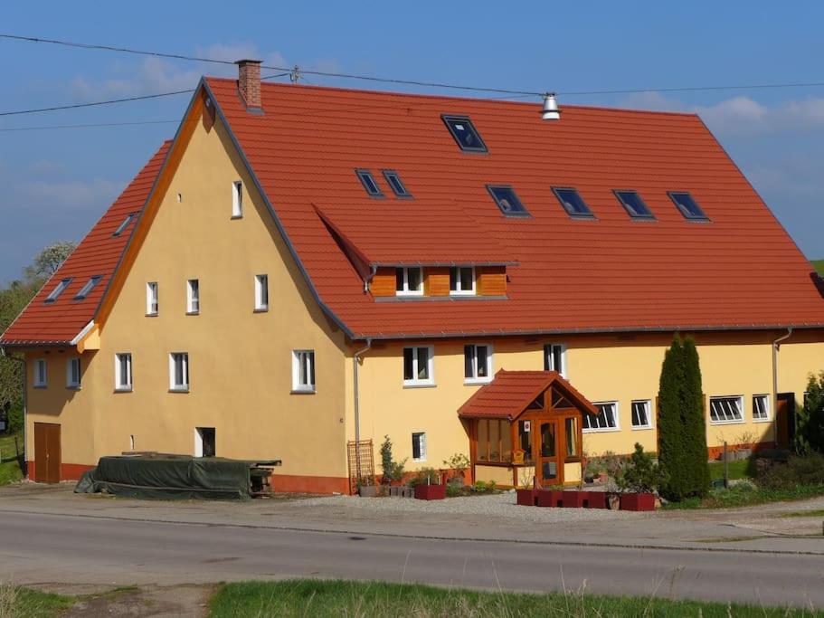 une grande maison jaune avec un toit rouge dans l'établissement Wutachschlucht - spacious apartment in renovated farmhouse, à Bonndorf im Schwarzwald