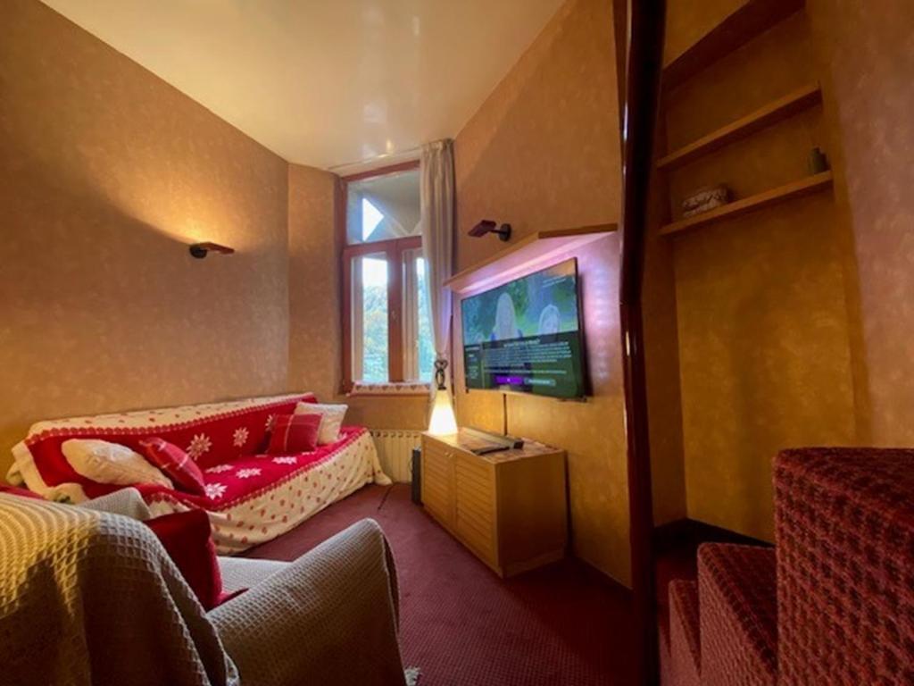 Habitación pequeña con cama y TV. en THE NEST Alpine Loft Ski-in Ski-out, en Breuil-Cervinia