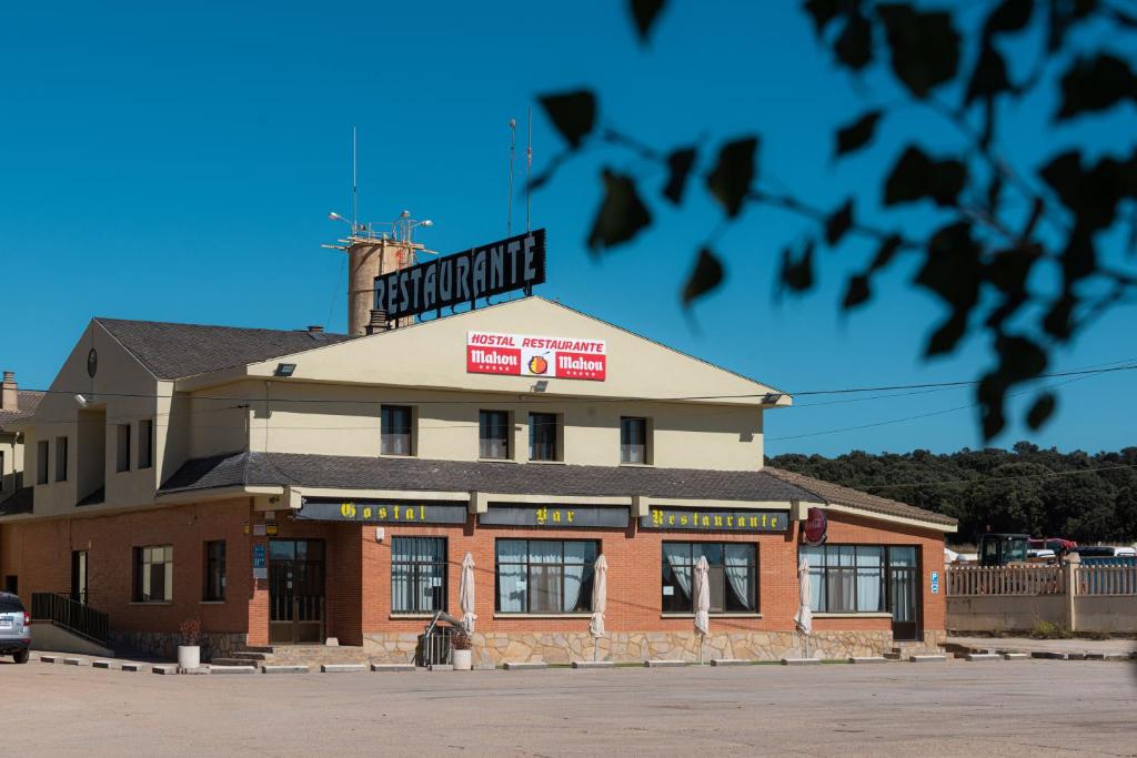 a building with a sign on top of it at Hostal Venta de Valcorba in Soria