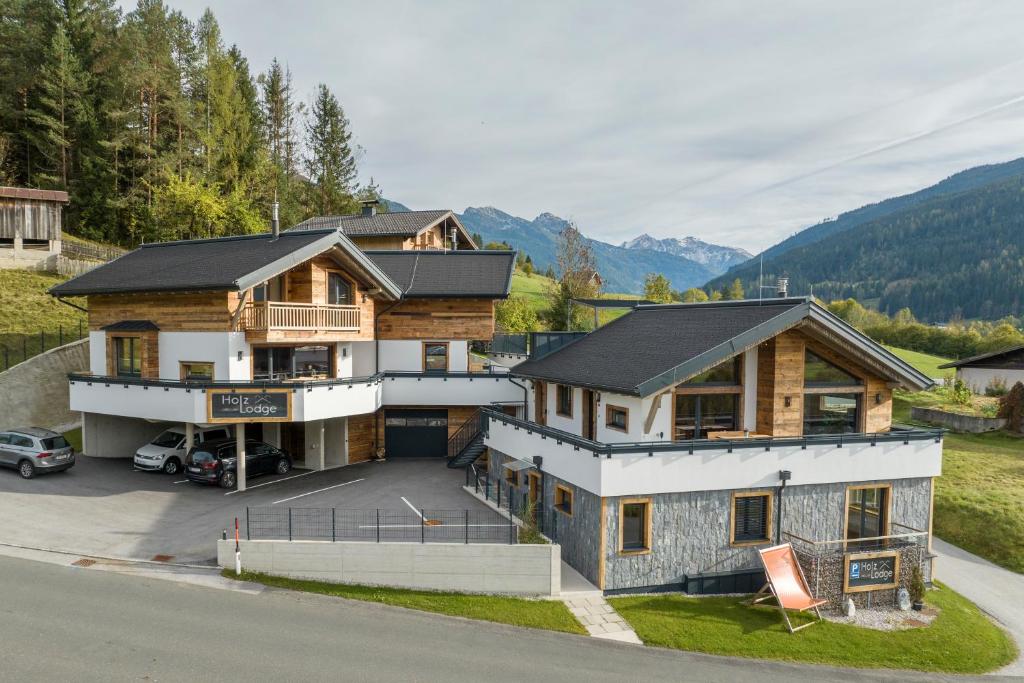 an aerial view of a house with a parking lot at HOLZLODGE DELUXE - Alpine Chalets - Bergblick Radstadt in Radstadt