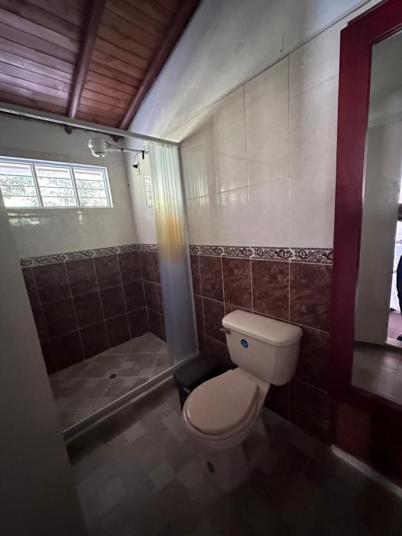 a bathroom with a toilet and a shower at EL PARAISO G - FINCA HOTEL LGBT - ADULTS ONLY in San Vicente