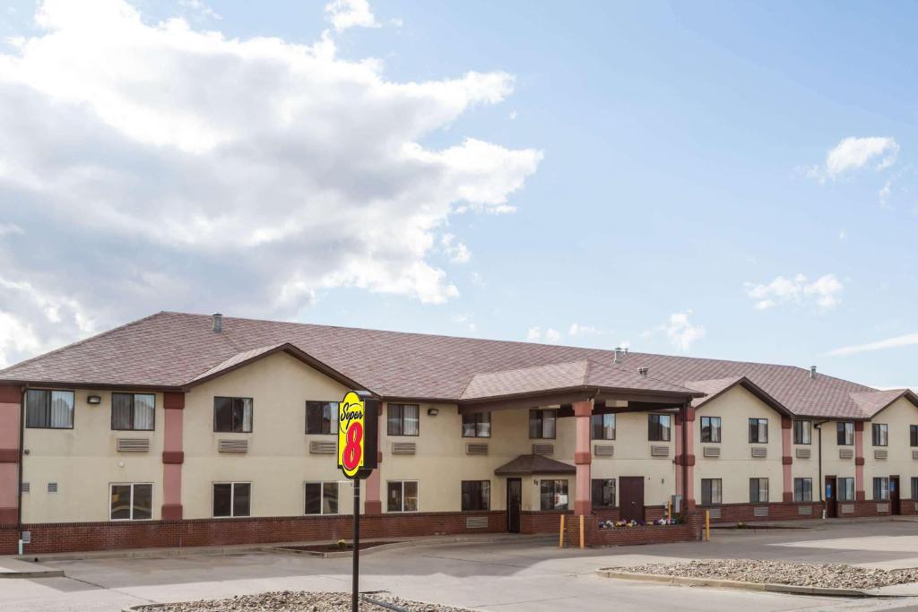 a large building with a sign in front of it at Super 8 by Wyndham Rock Springs in Rock Springs