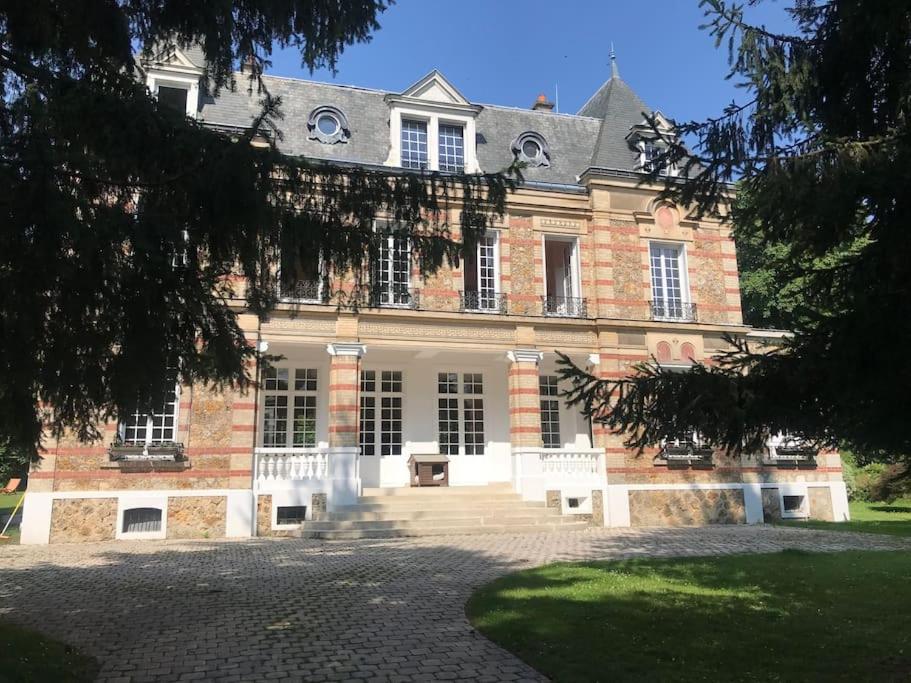 a large brick building with a large driveway at Appartement de 100m2 dans un parc à 20 mn du centre de Paris in Garches