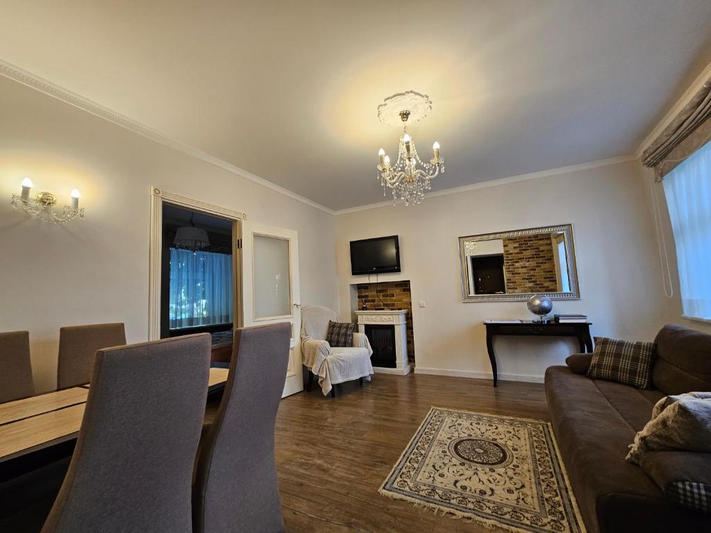 a living room with a table and a dining room at Vilnius City Walls apartment in Vilnius