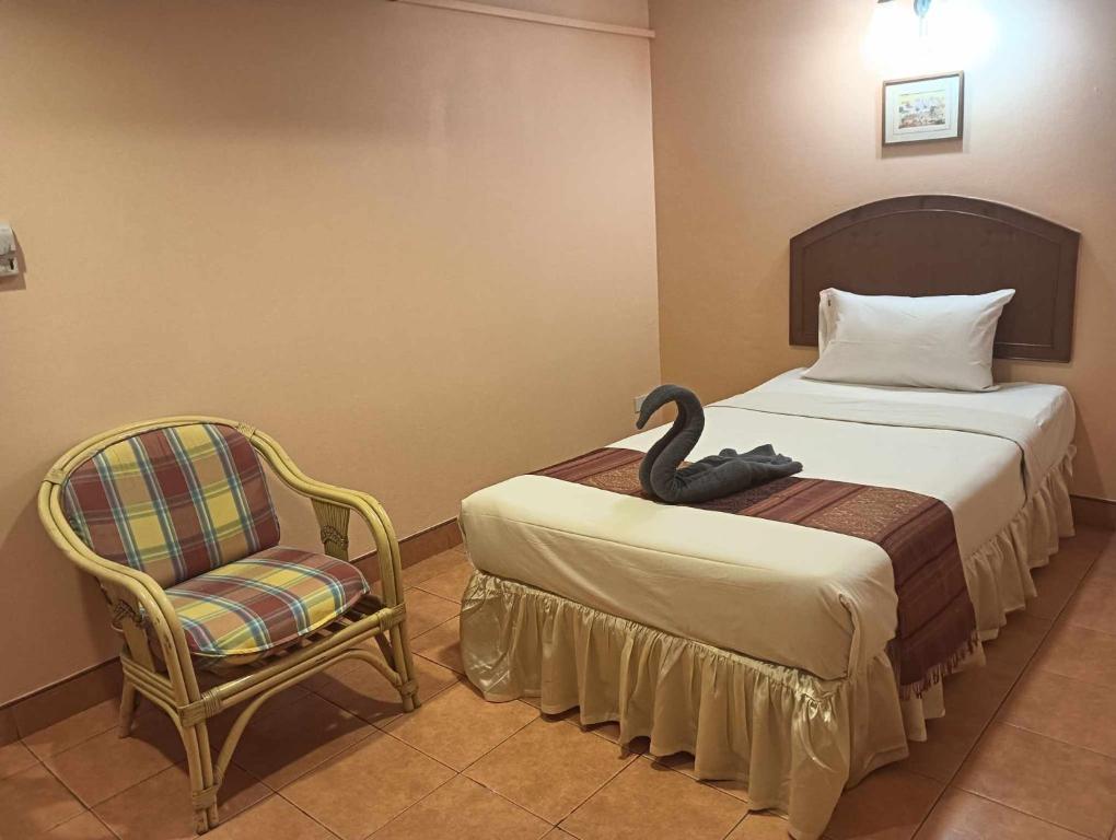 Postel nebo postele na pokoji v ubytování Nid Huahin Hotel
