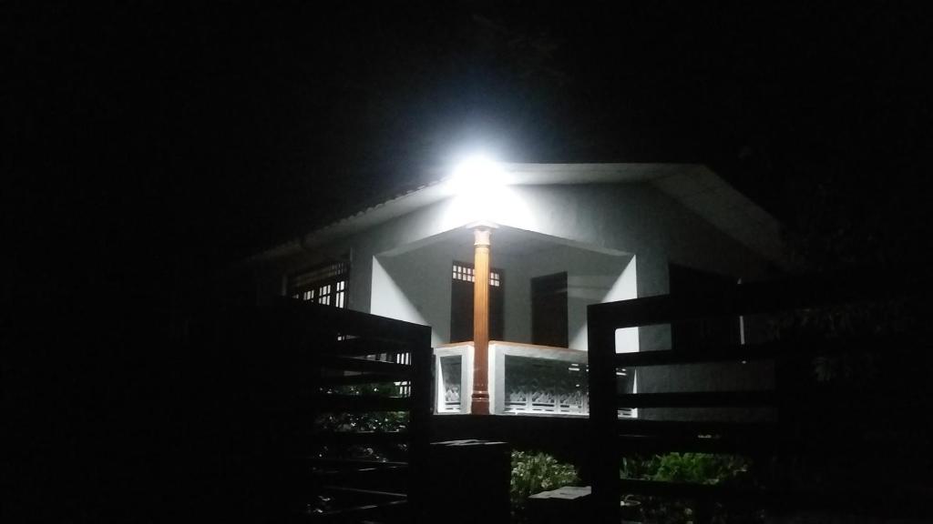 a light on the side of a building at night at Rock house kurunegala in Kurunegala