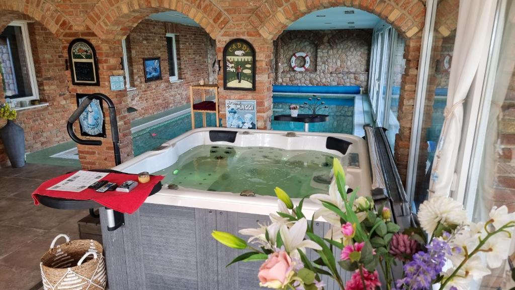 a bath tub filled with water in a room at Virág Wellness Villa in Pécs