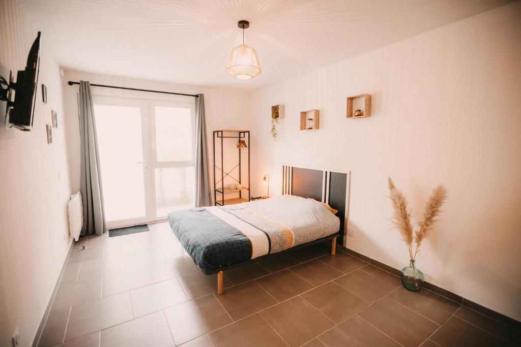 um quarto com uma cama e uma grande janela em Franc-Bisontin - Unique ! 4 logements disponibles em Besançon