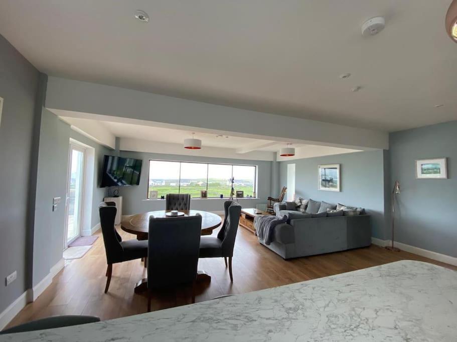 a living room with a couch and a table at Inis Mor, Aran Islands Luxury 5 bedroom with Seaviews 
