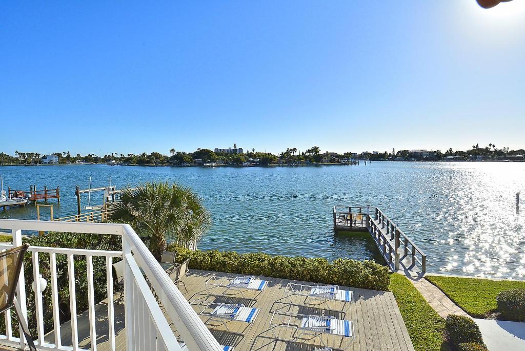 a view of a lake with chairs and a dock at Amadeus 3 in St. Pete Beach