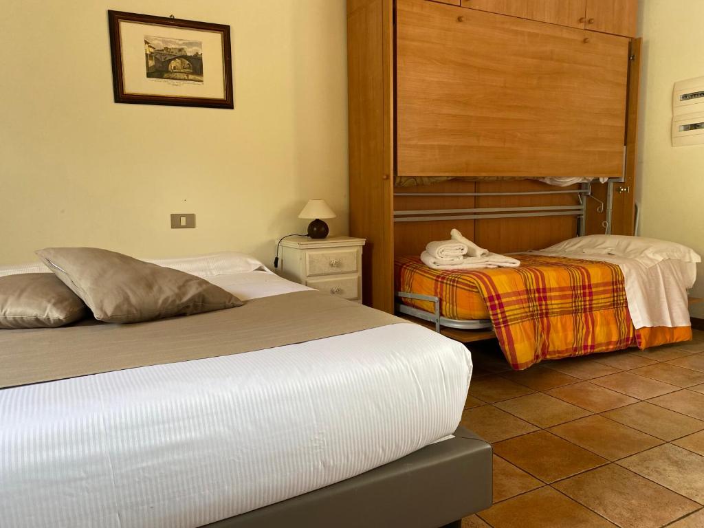 A bed or beds in a room at La Locanda dei Golosi