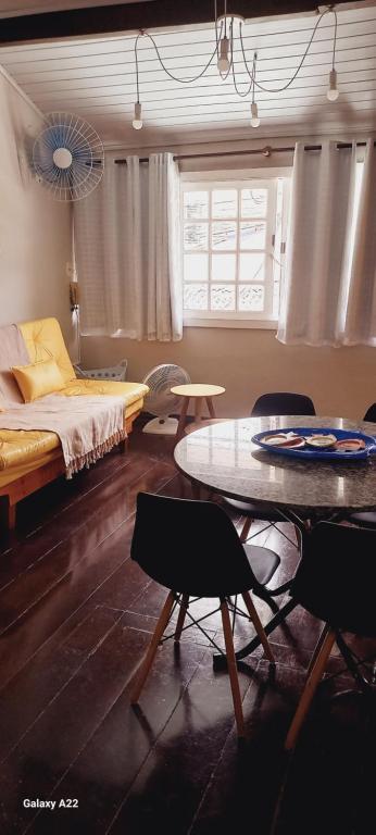1 dormitorio con 1 cama, mesa y sillas en Apart Coração de Búzios, en Búzios